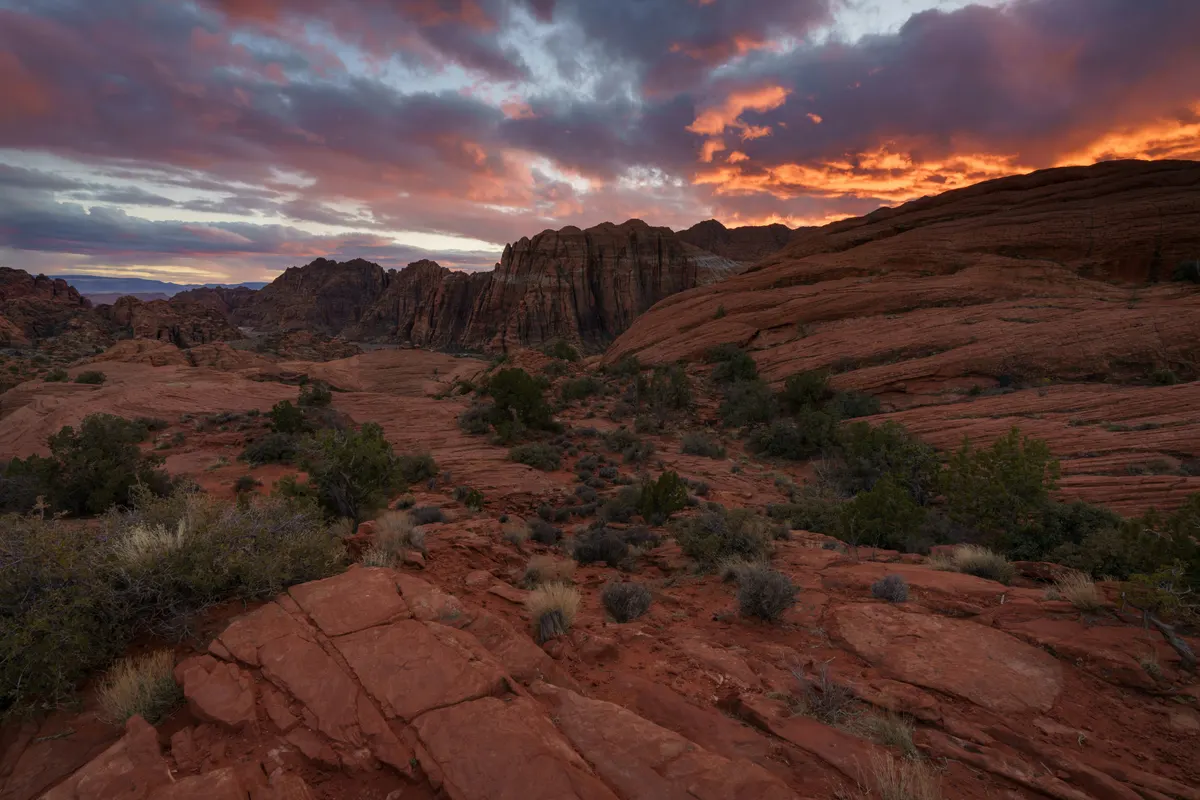 Sunset over the banded red sandstone of Snow Canyon State Park at the edge of Ivins, Utah